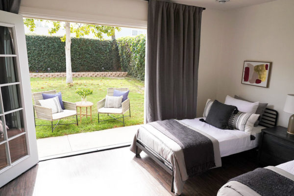 Hermosa Beach Treatment Center Bedroom with doors open to the enclosed back yard area